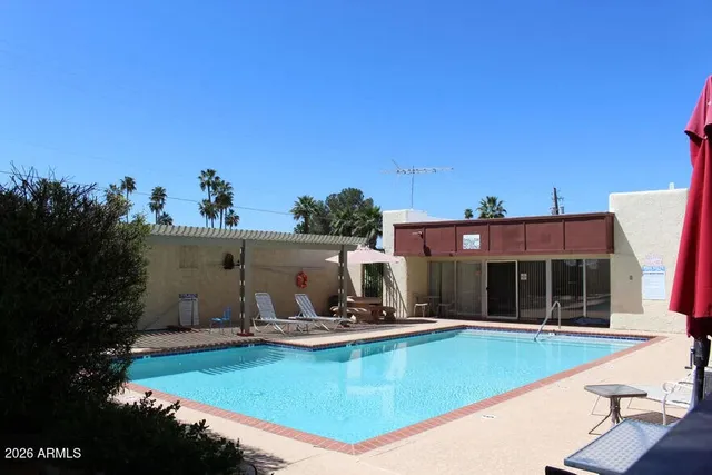 a view of a swimming pool with a lawn chairs