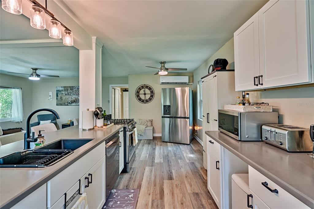 113 Stock Avenue Interlachen, FL 32148 - Photo 11 of 62 a kitchen with kitchen island granite countertop a sink appliances cabinets and counter space