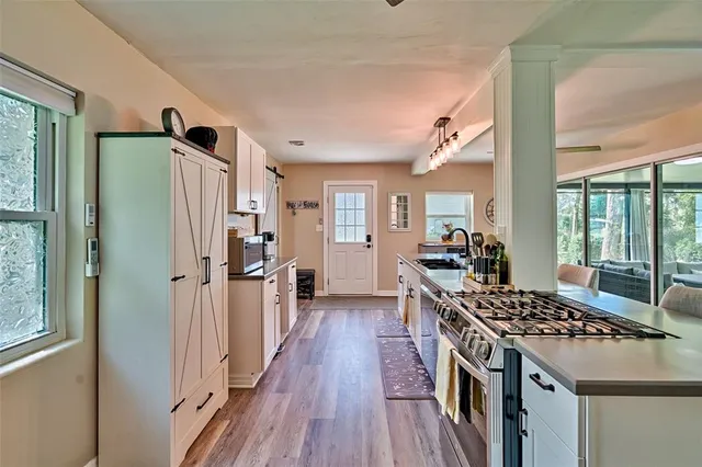 a living room with furniture tv and a large window