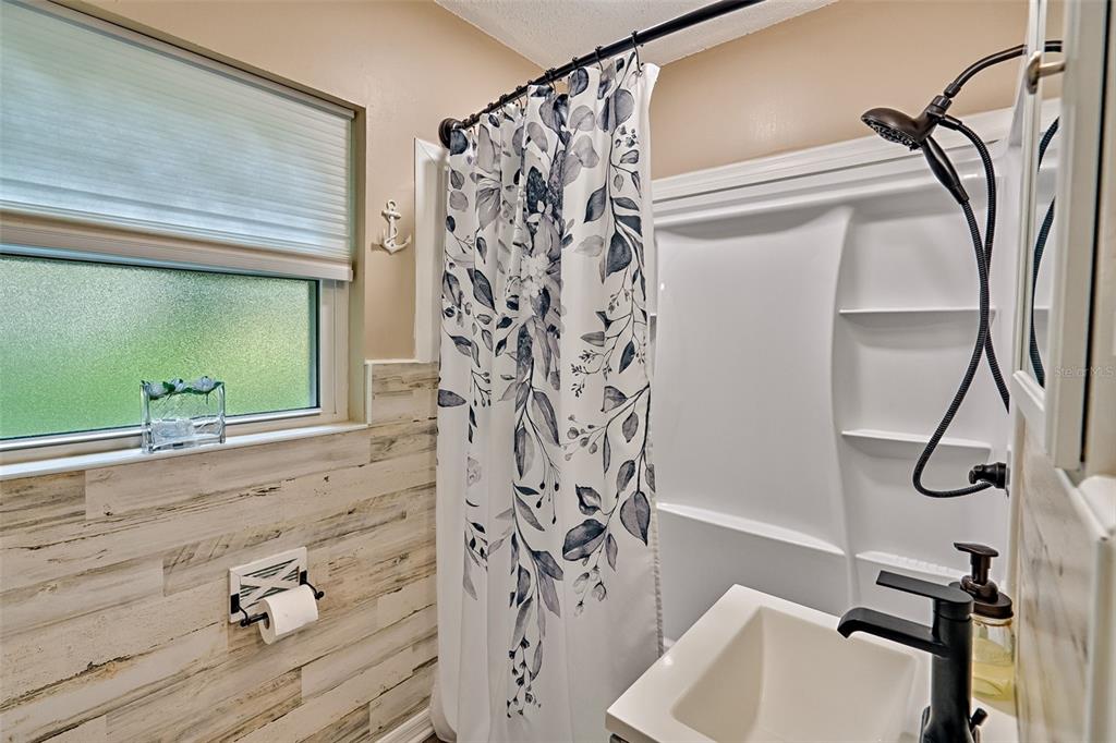 113 Stock Avenue Interlachen, FL 32148 - Photo 25 of 62 a bathroom with a shower curtain and a sink