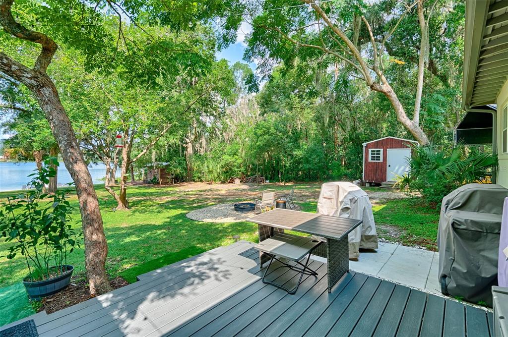 113 Stock Avenue Interlachen, FL 32148 - Photo 30 of 62 a view of a wooden deck and a backyard