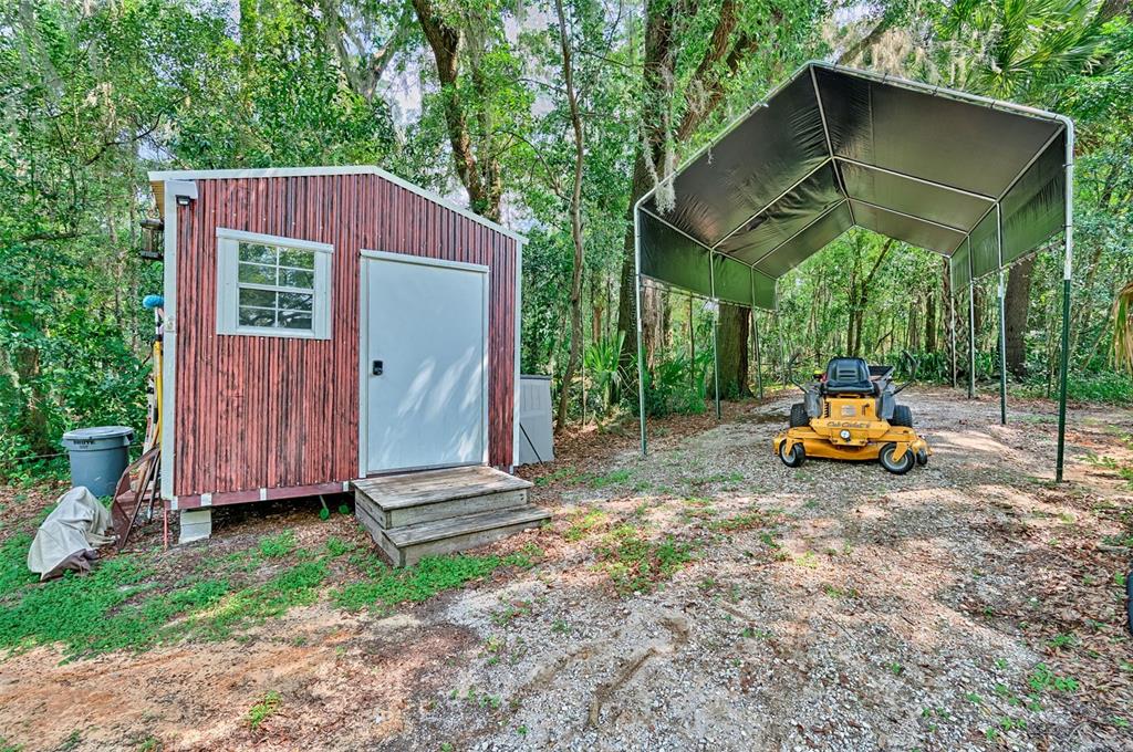 113 Stock Avenue Interlachen, FL 32148 - Photo 31 of 62 a backyard of a house with barbeque oven table and chairs