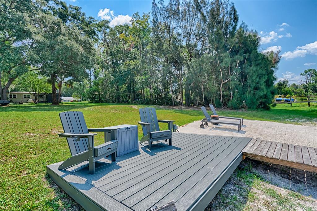 113 Stock Avenue Interlachen, FL 32148 - Photo 46 of 62 a view of a chairs and table on the wooden deck