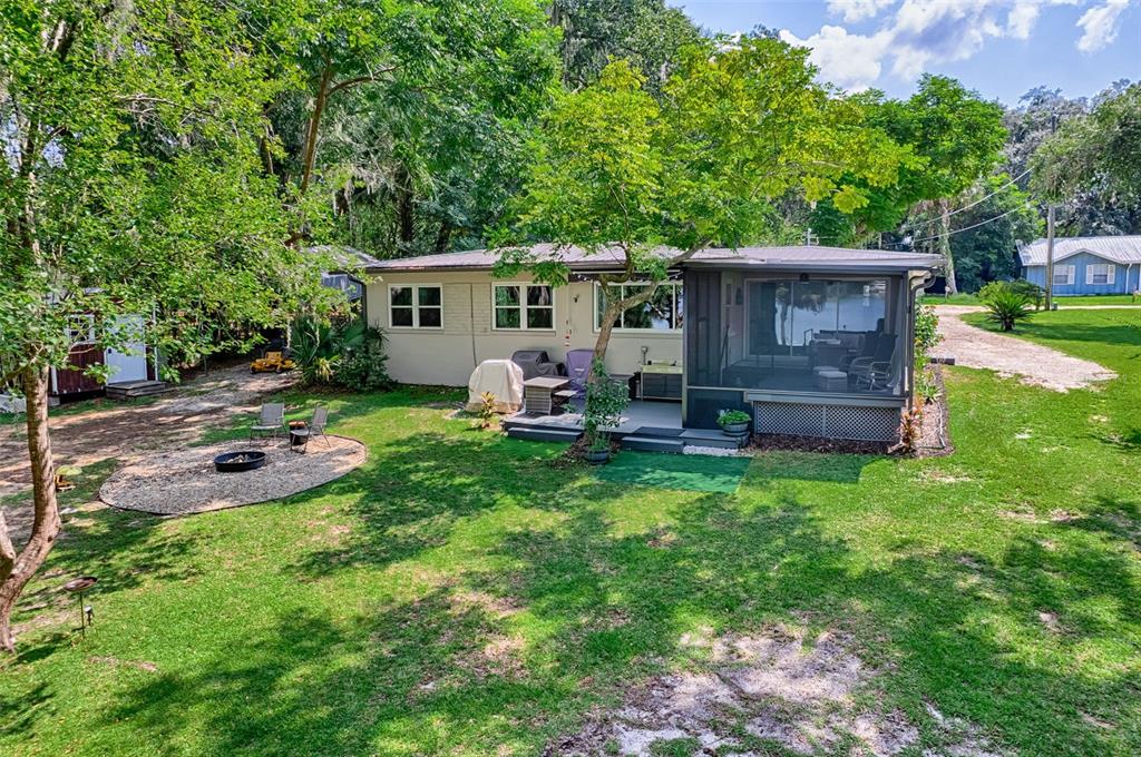 113 Stock Avenue Interlachen, FL 32148 - Photo 49 of 62 a backyard of a house with seating space