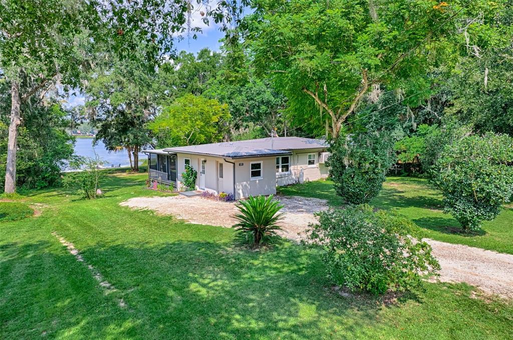 113 Stock Avenue Interlachen, FL 32148 - Photo 5 of 62 a front view of a house with garden