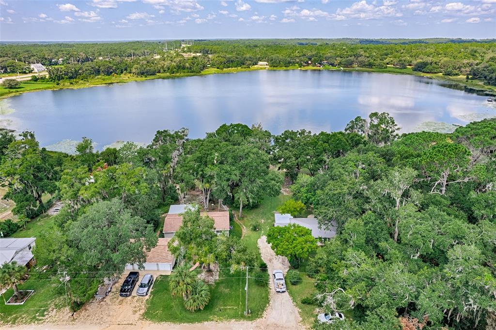 113 Stock Avenue Interlachen, FL 32148 - Photo 55 of 62 an aerial view of a house with a yard and a bench