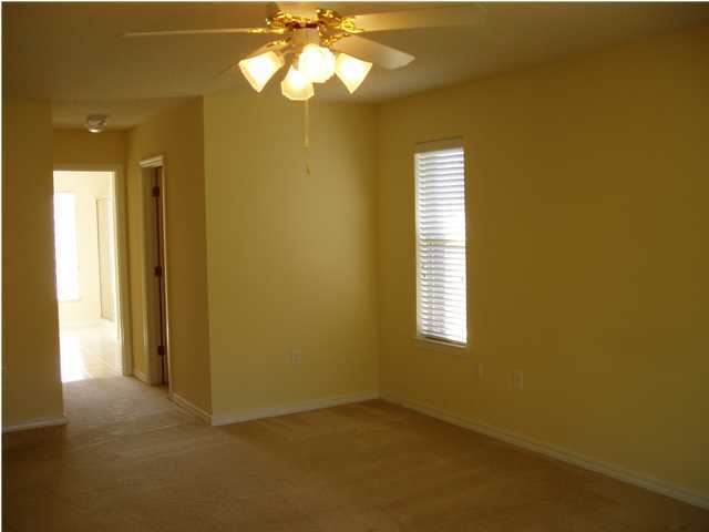 6894 Fernandina Road Navarre, FL 32566 - Photo 12 of 17 a view of empty room with windows