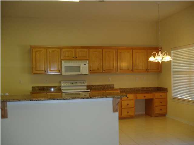 6894 Fernandina Road Navarre, FL 32566 - Photo 5 of 17 a view of kitchen cabinets and wooden floor