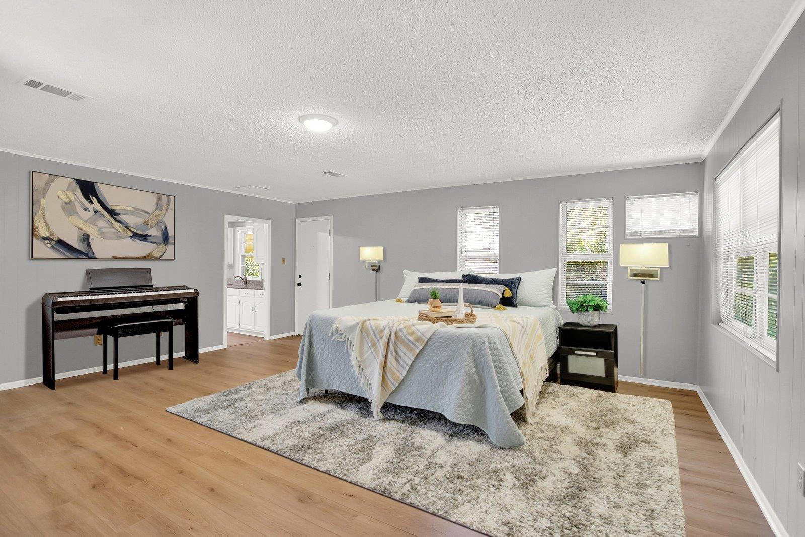 4892 Amboy Road Memphis, TN 38117 - Photo 18 of 26 a bedroom with a bed lamps and a dresser