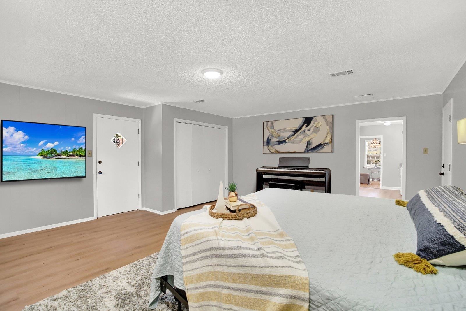 4892 Amboy Road Memphis, TN 38117 - Photo 19 of 26 a bedroom with a bed and a flat screen tv