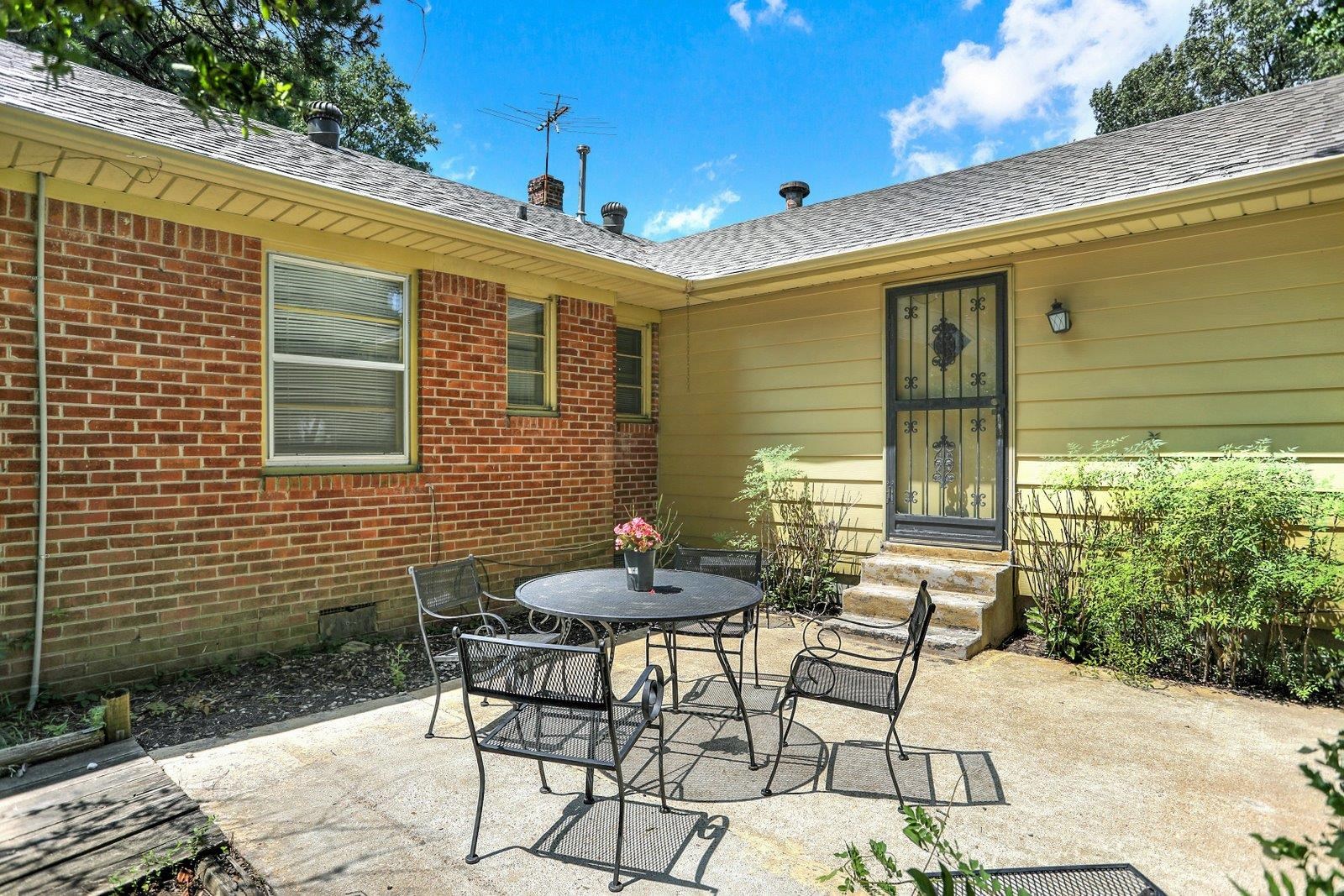 4892 Amboy Road Memphis, TN 38117 - Photo 25 of 26 a patio with table and chairs and potted plants