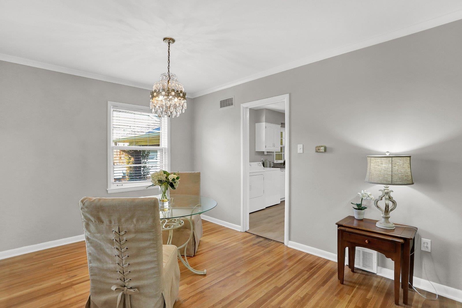4892 Amboy Road Memphis, TN 38117 - Photo 5 of 26 a dining room with furniture a chandelier and wooden floor