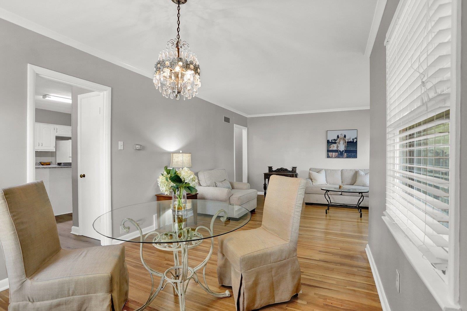 4892 Amboy Road Memphis, TN 38117 - Photo 6 of 26 a living room with dining table furniture and a chandelier
