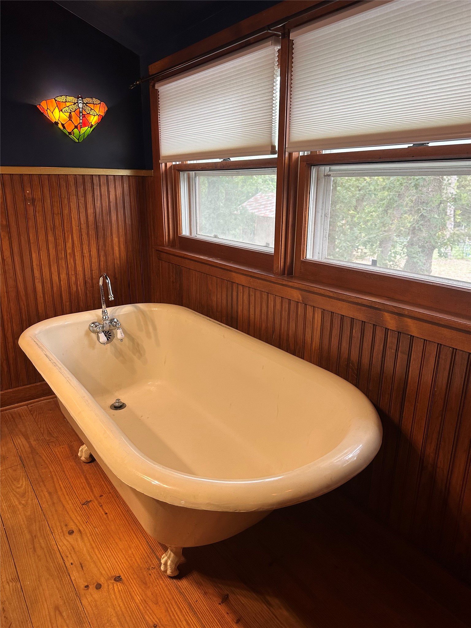 1053 East County Rd F Lexington, TX 78947 - Photo 17 of 38 a white bath tub sitting in a bathroom next to a window