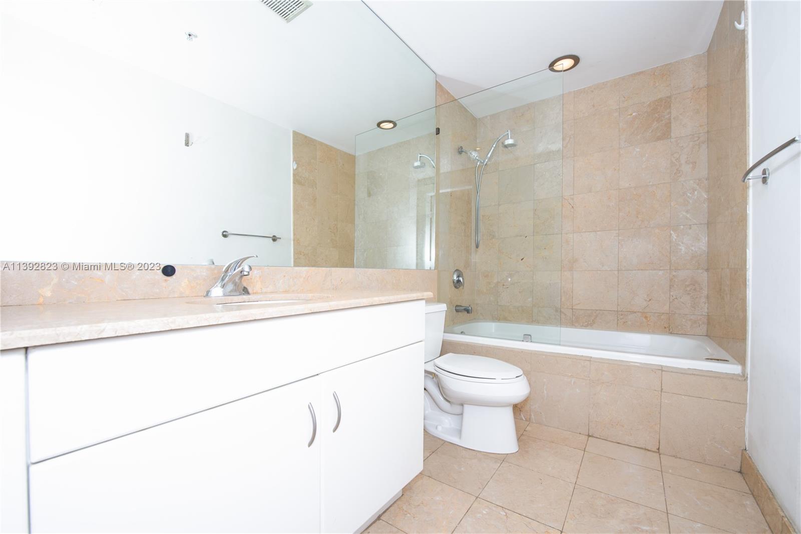 Brickell Miami, FL 33131 - Photo 18 of 50 a bathroom with a sink a toilet and shower