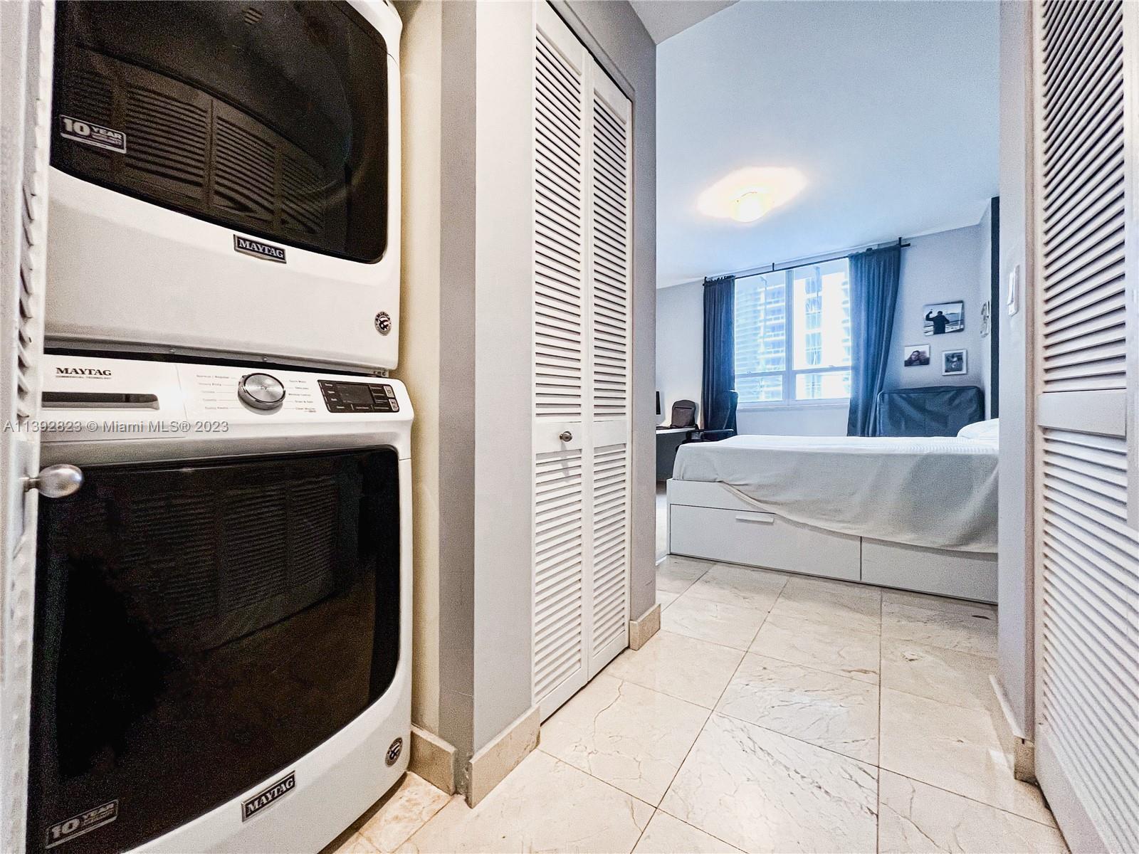 Brickell Miami, FL 33131 - Photo 21 of 50 a bedroom with a bed and a washing machine