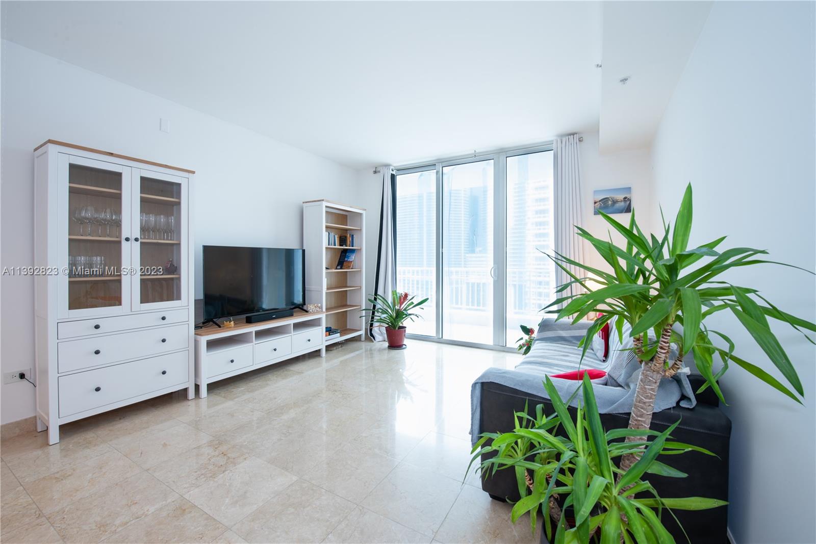 Brickell Miami, FL 33131 - Photo 5 of 50 a living room with furniture and a flat screen tv