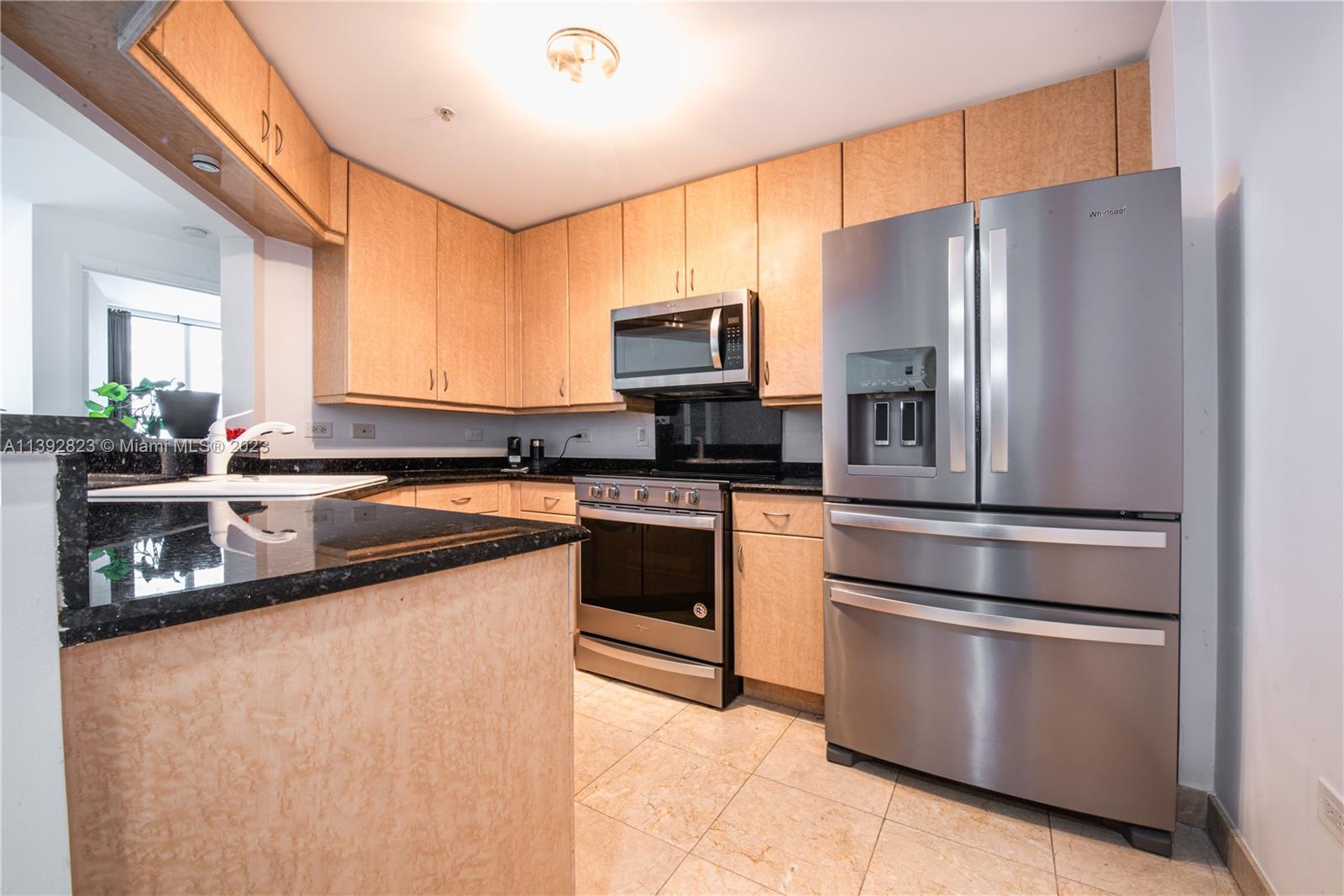 Brickell Miami, FL 33131 - Photo 9 of 50 a kitchen with granite countertop a refrigerator stove and sink