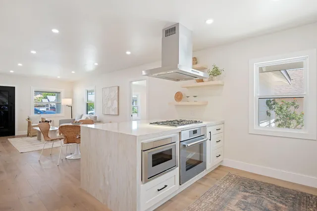 a large bed sitting in a bedroom next to a window