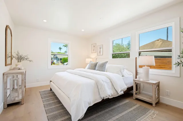 a living room with furniture a rug and a window