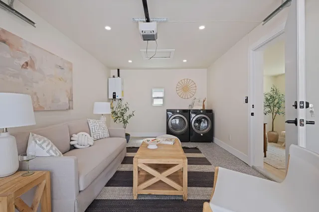an aerial view of a city with lots of residential buildings and mountain view in back