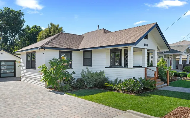 a front view of a house with a garden