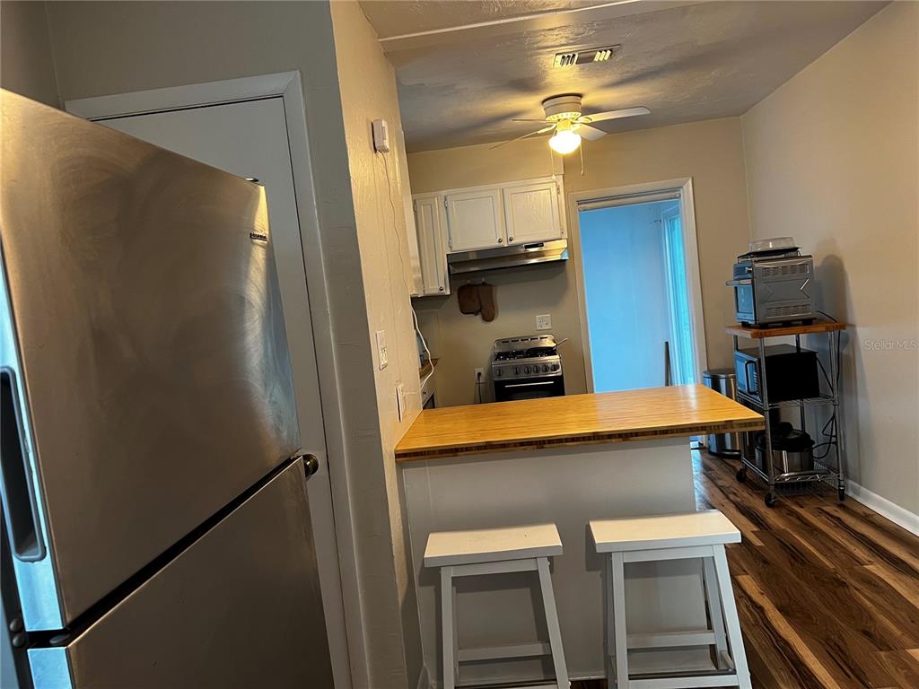408 Northeast 18th Street Gainesville, FL 32641 - Photo 2 of 8 a kitchen with a refrigerator and a sink