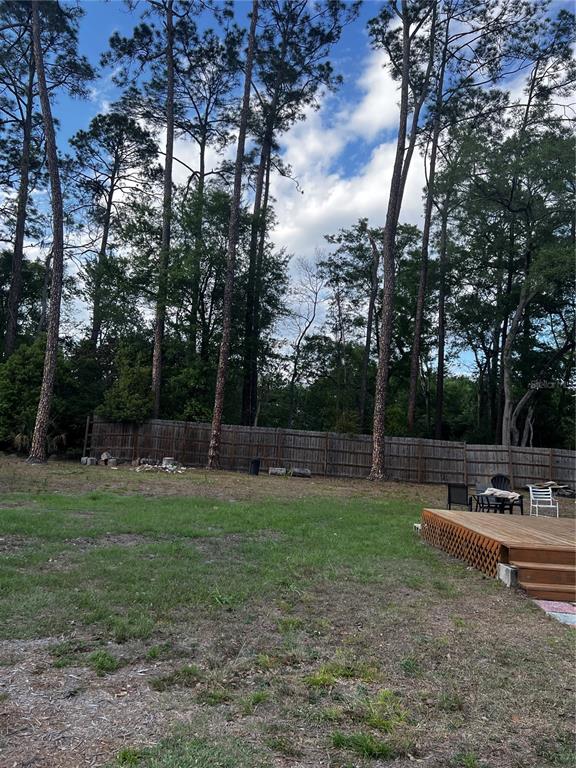 408 Northeast 18th Street Gainesville, FL 32641 - Photo 8 of 8 a backyard of a house with lots of green space