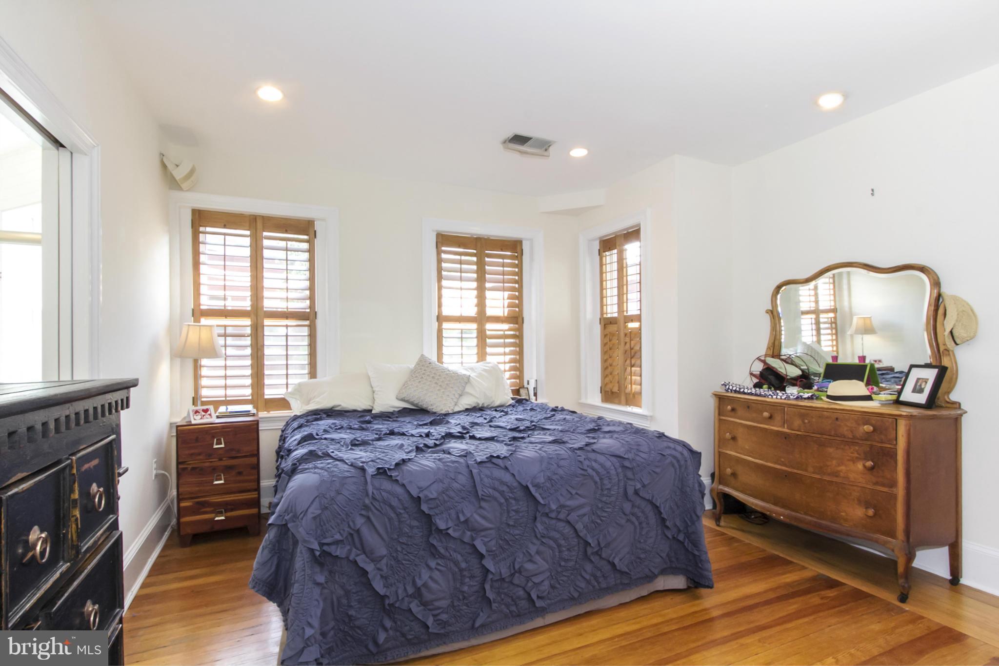 1423 R Street Northwest, Unit 505 Washington, DC 20009 - Photo 12 of 22 a bedroom with a bed and wooden floor