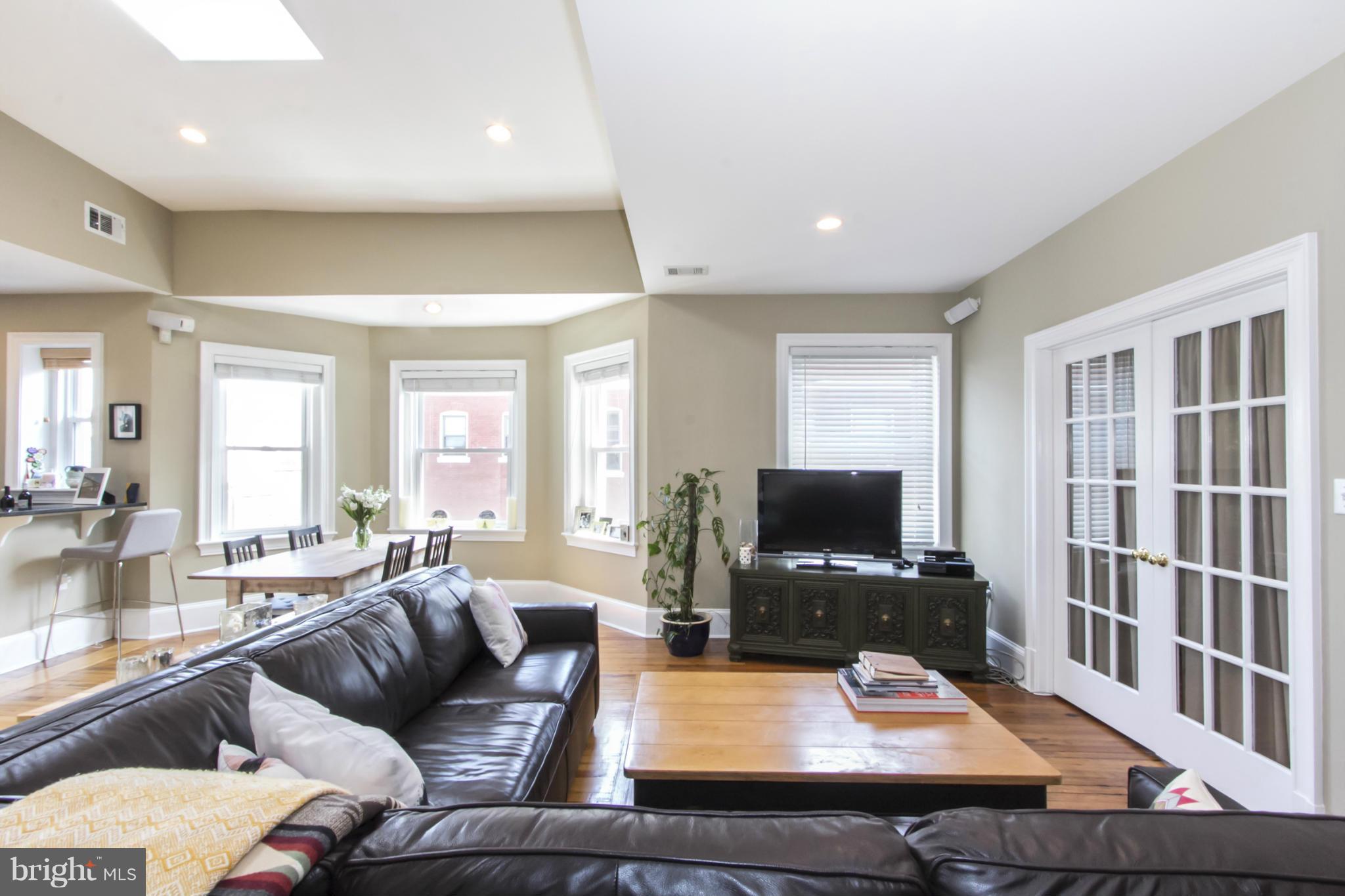 1423 R Street Northwest, Unit 505 Washington, DC 20009 - Photo 4 of 22 a living room with furniture and a flat screen tv