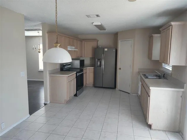 a kitchen with a sink a stove and refrigerator