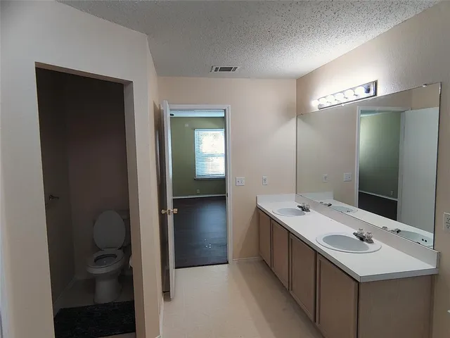 a bathroom with a double vanity sink and mirror