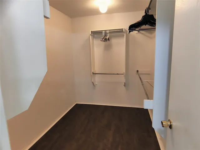 a view of closet with wooden floor