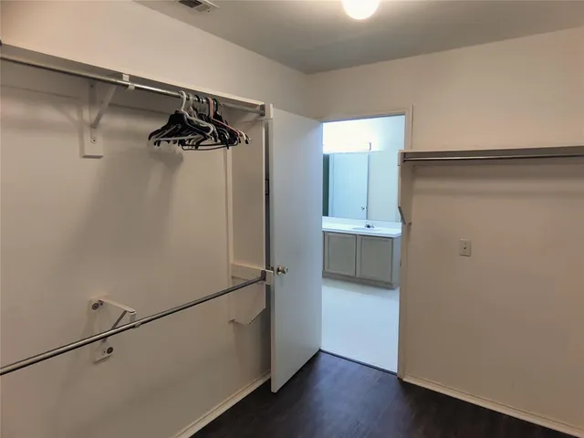 a view of walk in closet with empty racks