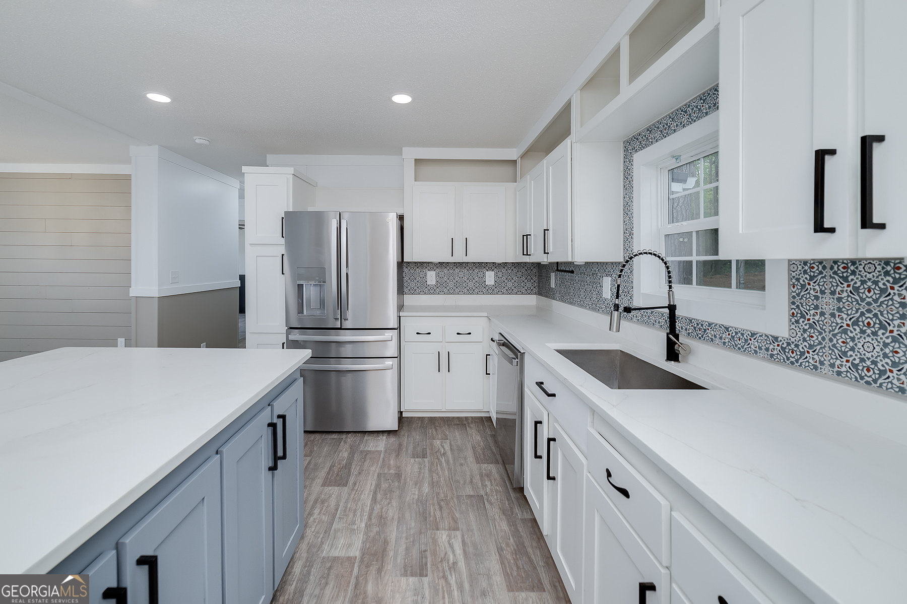 595 Barnetts Bridge Road Jackson, GA 30233 - Photo 21 of 47 a kitchen with a sink a stove a refrigerator and cabinets
