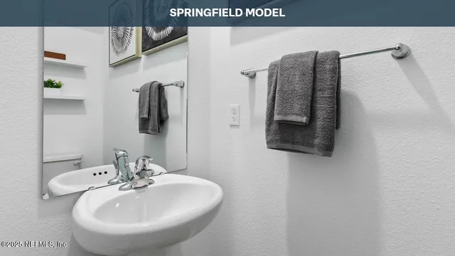 a bathroom with a sink and mirror