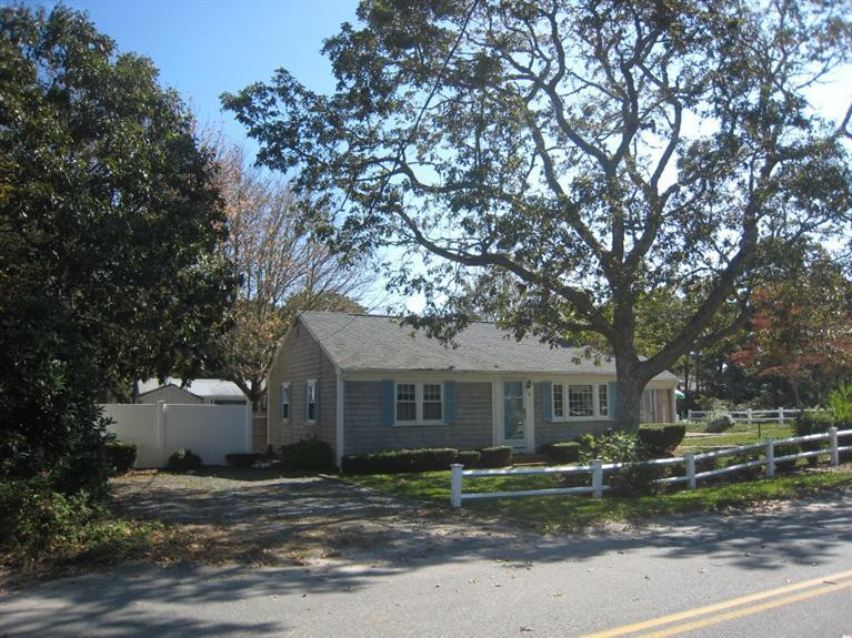 70 Captain Chase Road Dennis Port, MA 02639 - Photo 3 of 10 a front view of a house with a garden