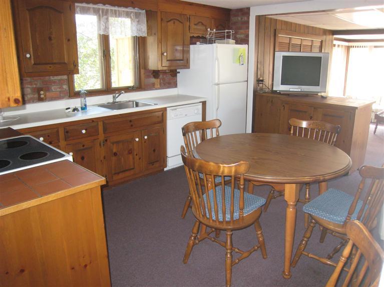 70 Captain Chase Road Dennis Port, MA 02639 - Photo 8 of 10 a open kitchen with a table chairs a refrigerator and a sink