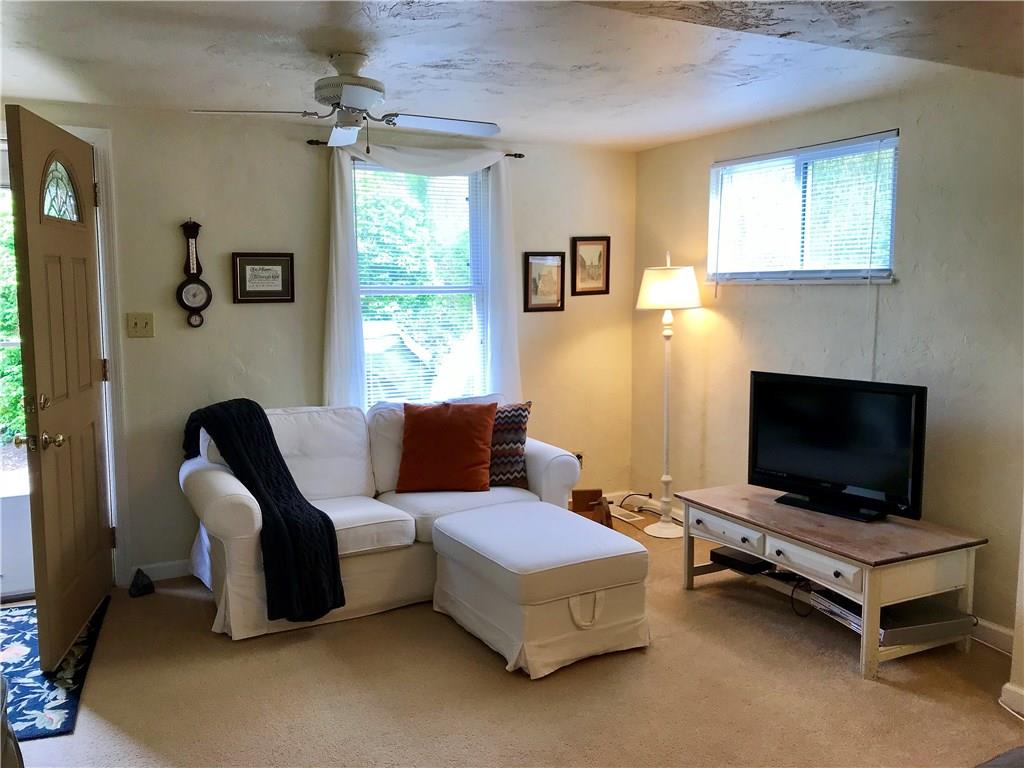 294 Idlewood Road Penn Hills, PA 15235 - Photo 2 of 25 Living room offers a ceiling fan, overhead lighting, newer carpet and so much natural light you will love to sit and read or watch your favorite show.