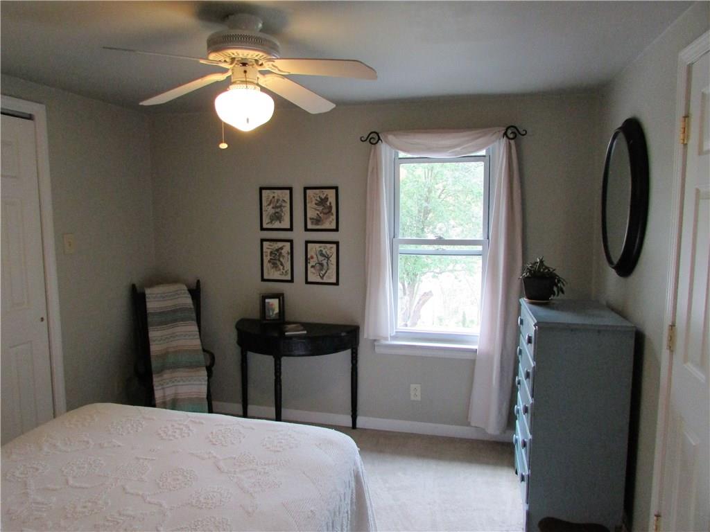 294 Idlewood Road Penn Hills, PA 15235 - Photo 11 of 25 4th bedroom located off the dining room has a full bath and measures 11x10, has a ceiling fan, storage galore and ample outlets. Window overlooks the rear yard with a peaceful park like setting