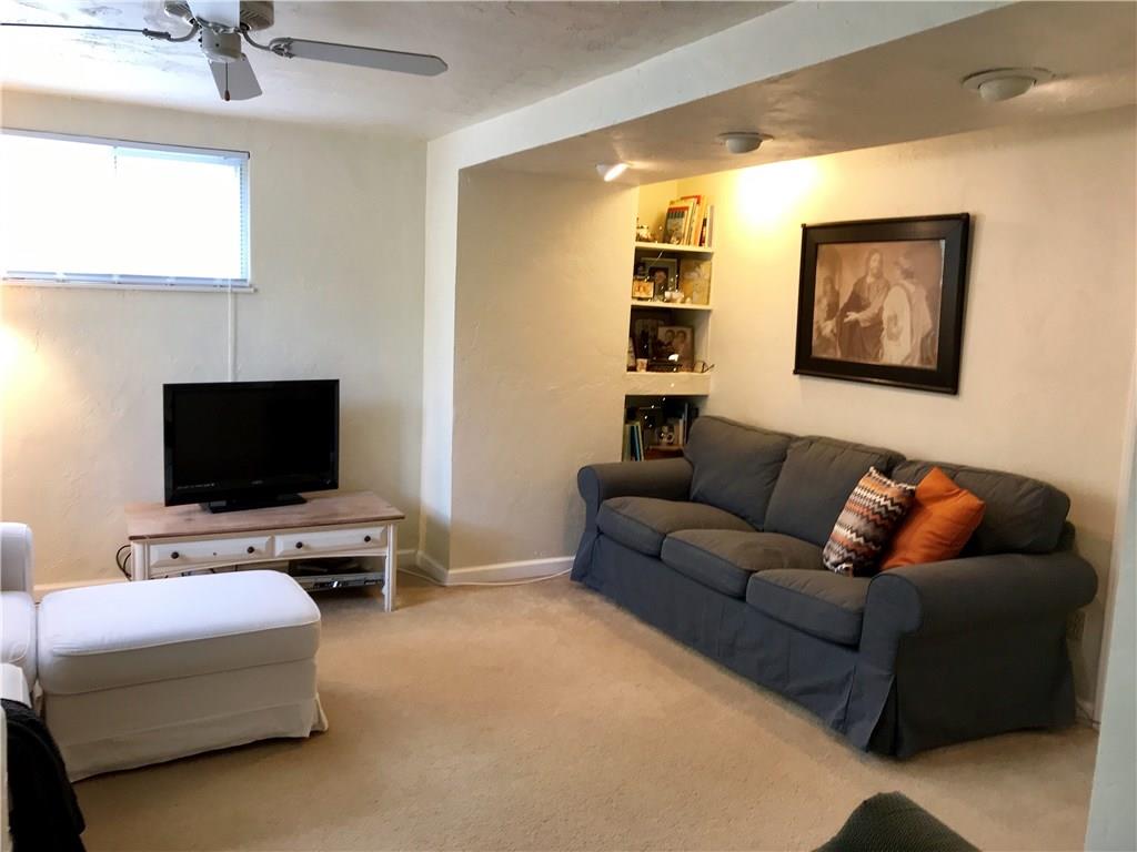294 Idlewood Road Penn Hills, PA 15235 - Photo 3 of 25 Living room has overhead lighting and built in book shelf, there is a coat closet/storage closet as well. Such a cozy and inviting space.
