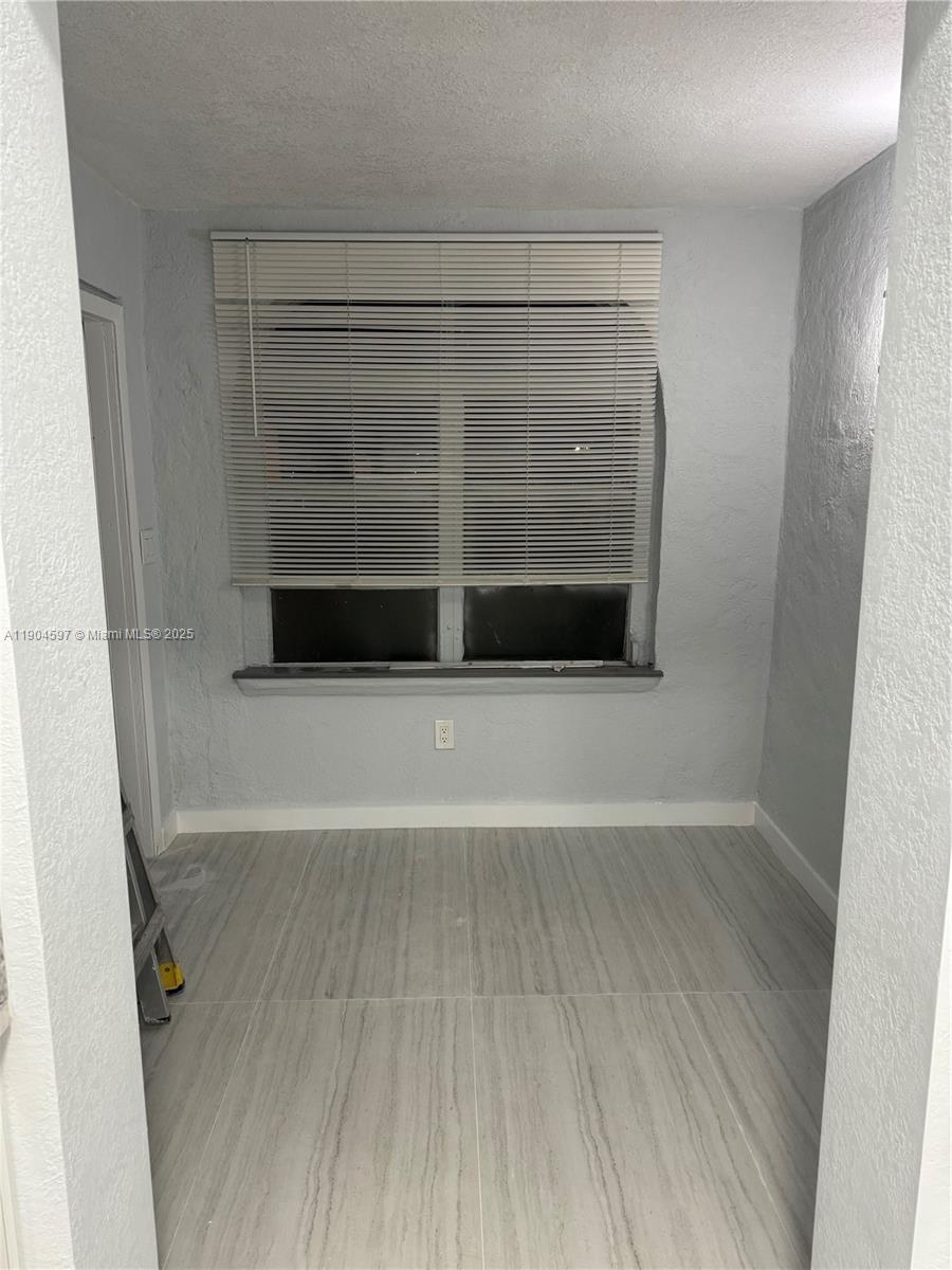 1101 Northwest 32nd Place, Unit MIDDLE Miami, FL 33125 - Photo 4 of 8 a view of wooden floor