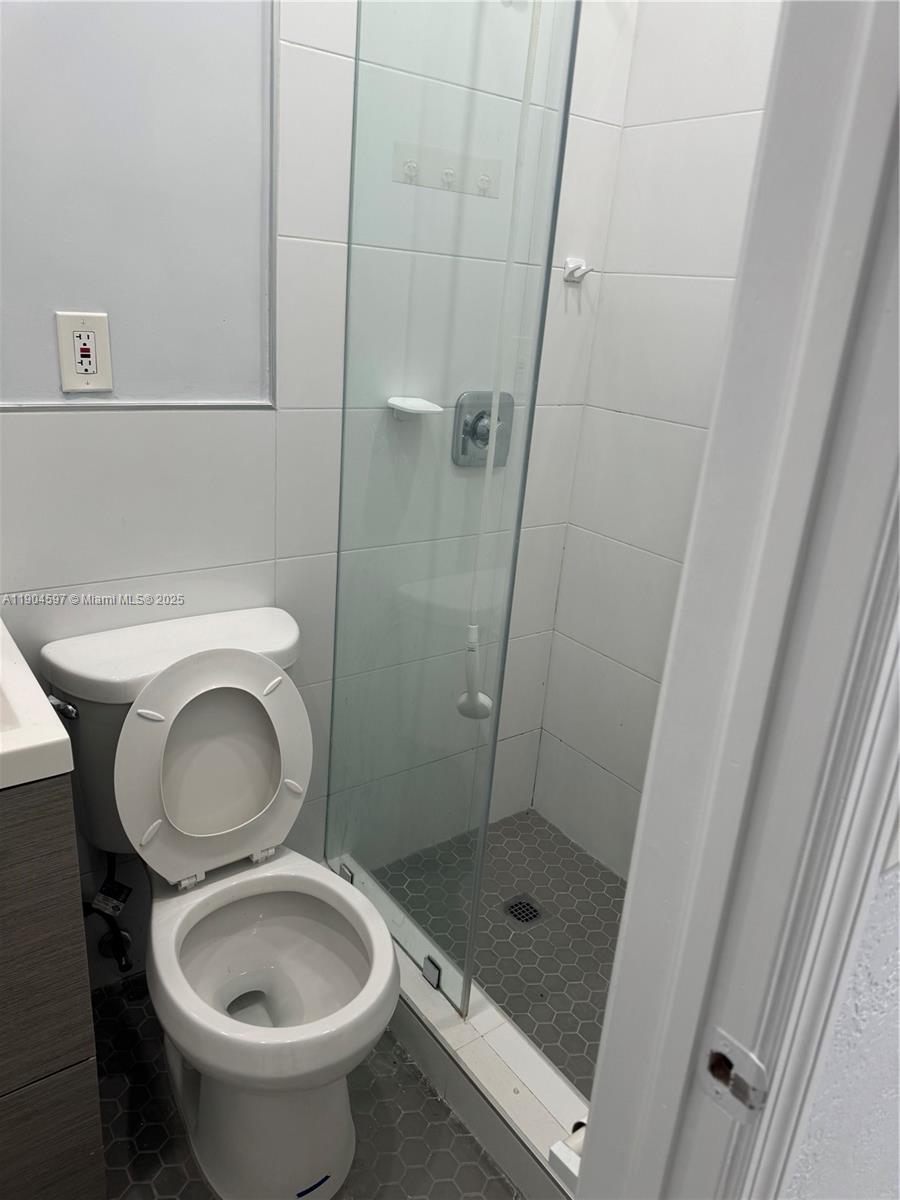 1101 Northwest 32nd Place, Unit MIDDLE Miami, FL 33125 - Photo 8 of 8 a bathroom with a toilet and a shower