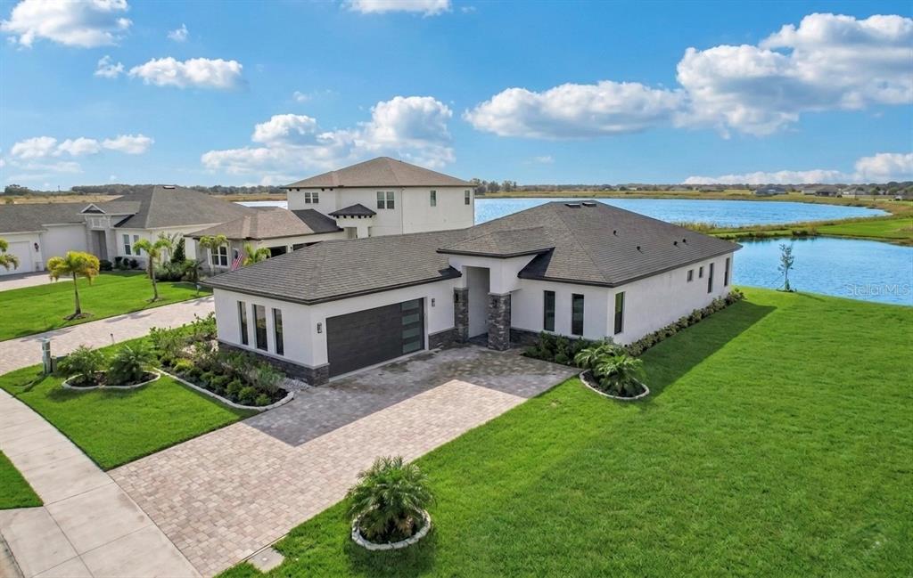 an aerial view of a house with yard porch and furniture