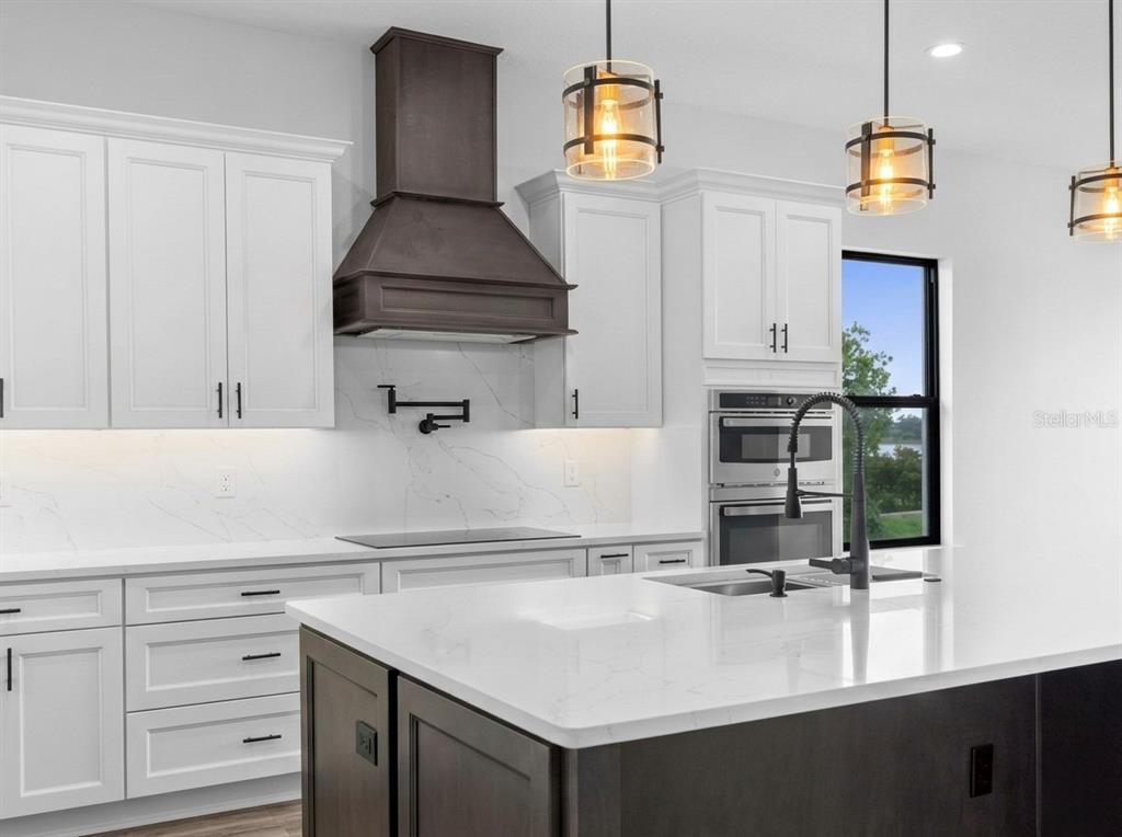224 Valencia Ridge Drive Auburndale, FL 33823 - Photo 11 of 39 a kitchen with a sink and a stove top oven