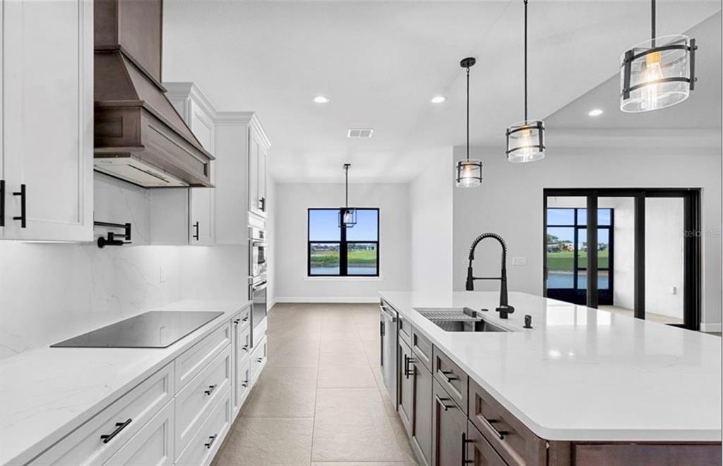 224 Valencia Ridge Drive Auburndale, FL 33823 - Photo 12 of 39 a kitchen with stainless steel appliances a sink a stove and wooden floors