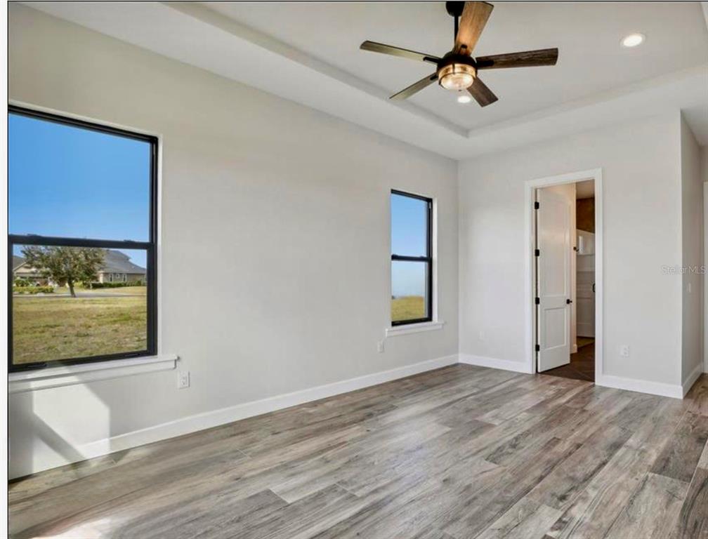 224 Valencia Ridge Drive Auburndale, FL 33823 - Photo 21 of 39 a view of an empty room with window and wooden floor