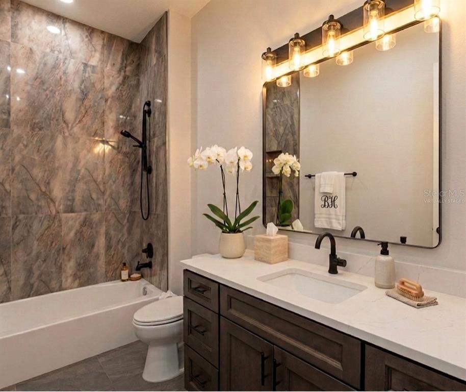 224 Valencia Ridge Drive Auburndale, FL 33823 - Photo 24 of 39 a bathroom with a double vanity sink toilet mirror and bathtub