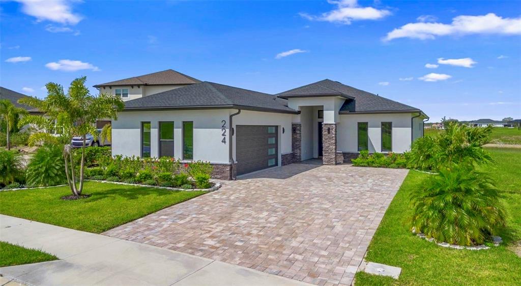 224 Valencia Ridge Drive Auburndale, FL 33823 - Photo 3 of 39 a front view of a house with a yard and garage