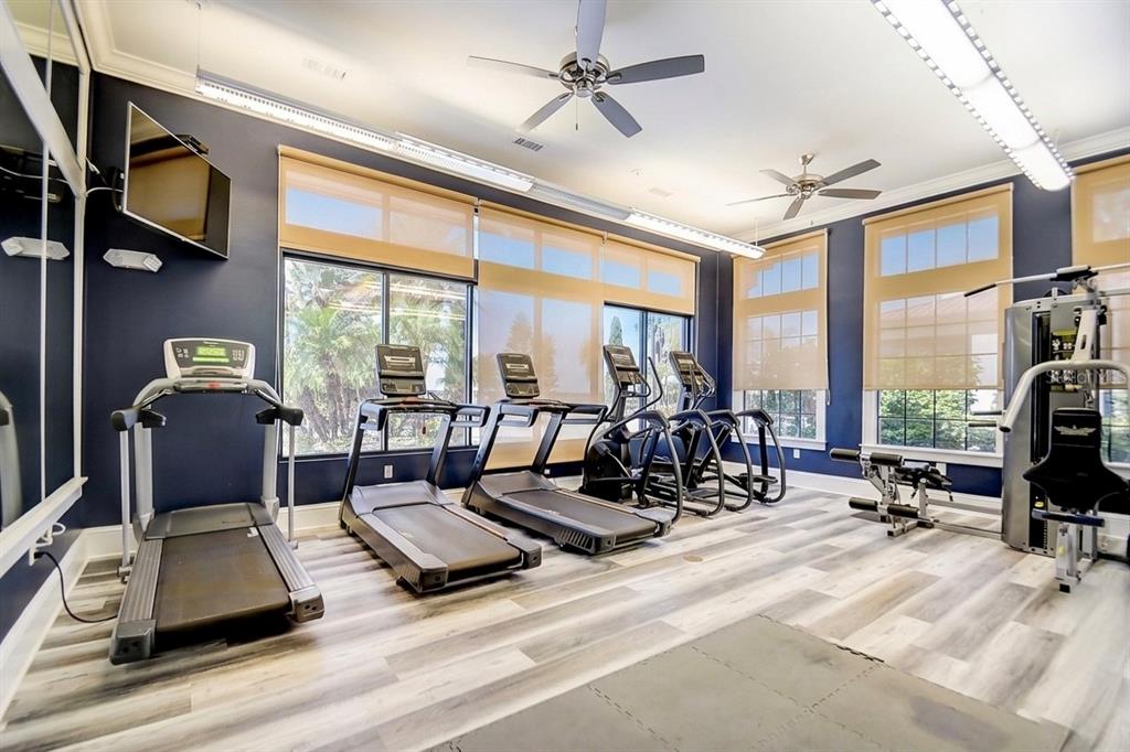 224 Valencia Ridge Drive Auburndale, FL 33823 - Photo 32 of 39 a living room with furniture gym equipment and a large window
